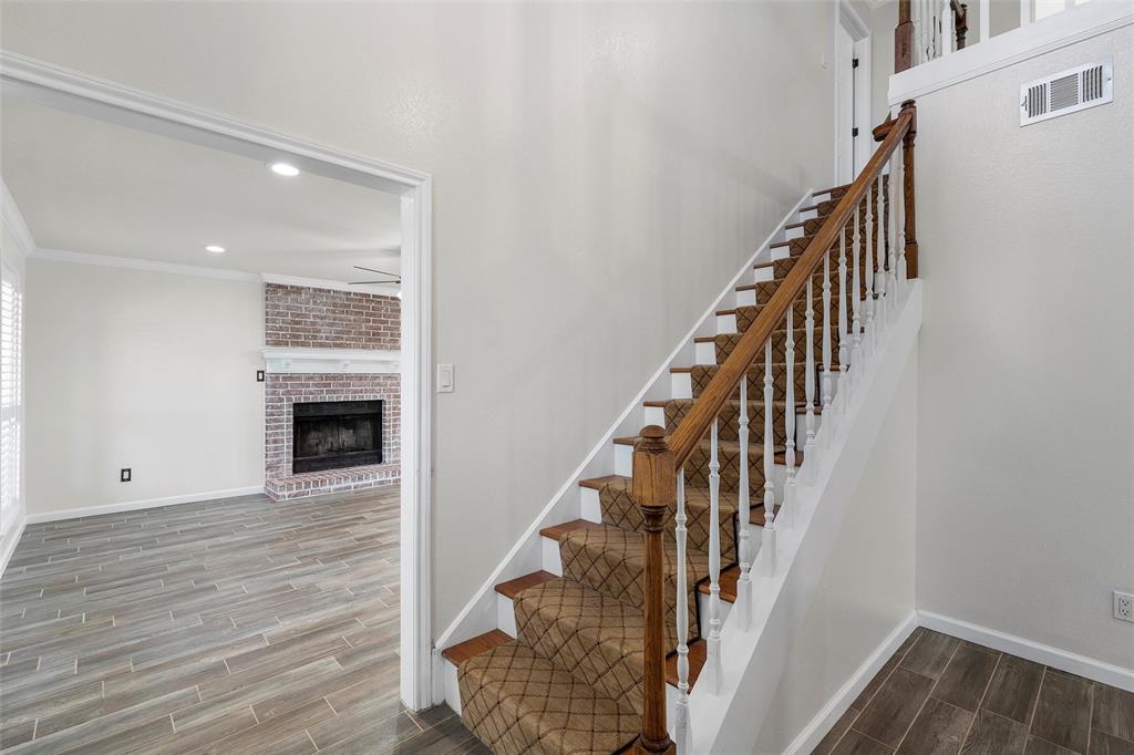 5112 Old Caufield Ranch Road McGregor, TX 76657 - Photo 19 of 38 Stairs with wood tiled floors, a fireplace, and recessed lighting