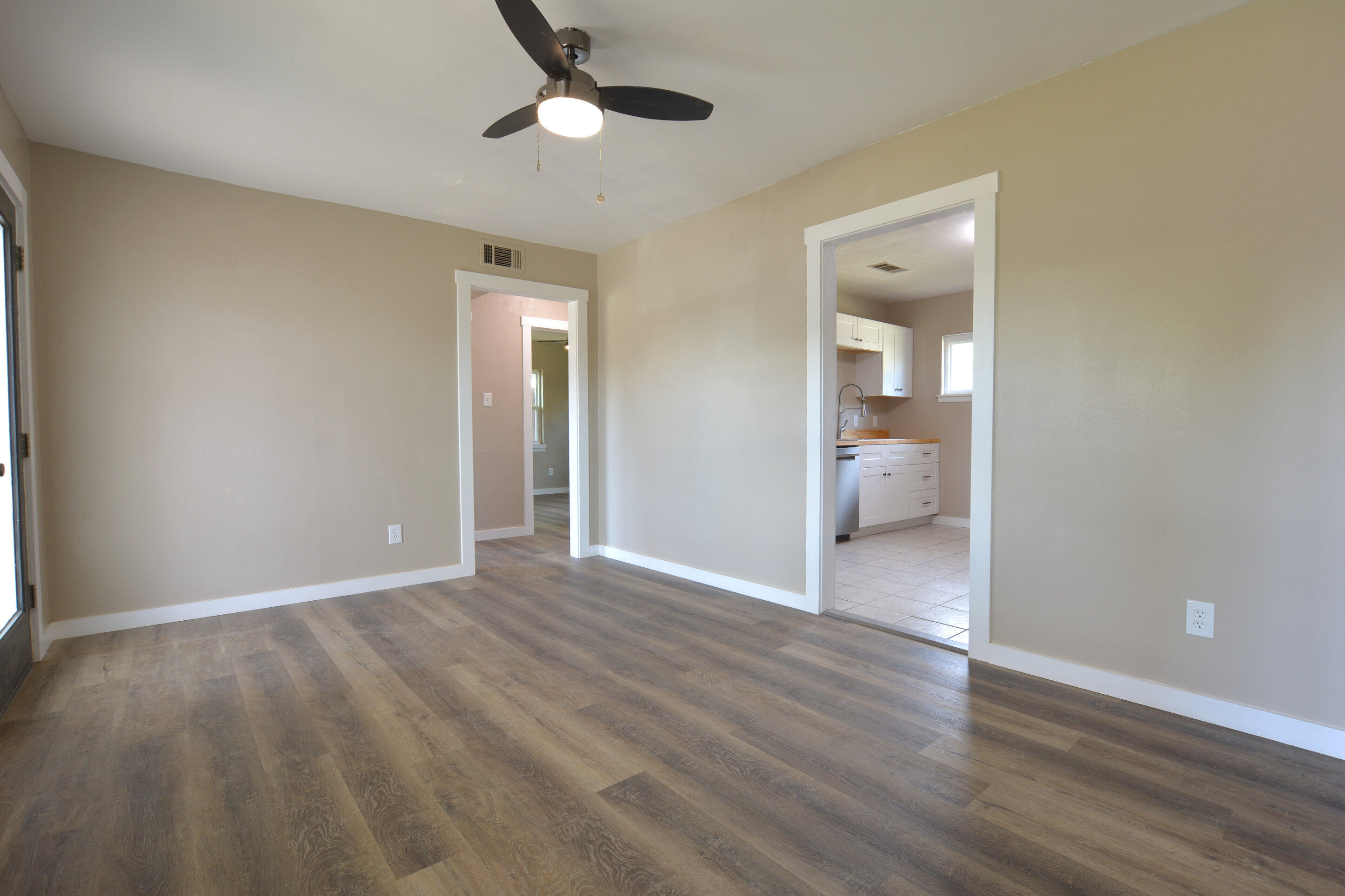 4608 Detroit Avenue Lubbock, TX 79413 - Photo 6 of 20 a view of a room with wooden floor and a bathroom