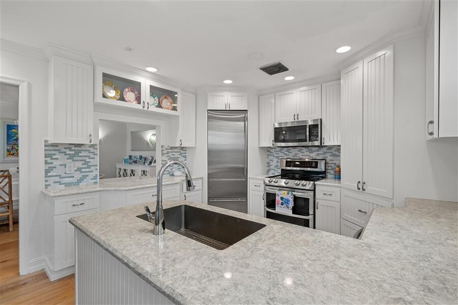 5111 North Ocean Boulevard, Unit A Ocean Ridge, FL 33435 - Photo 20 of 47 a kitchen with stainless steel appliances granite countertop a sink stove and refrigerator