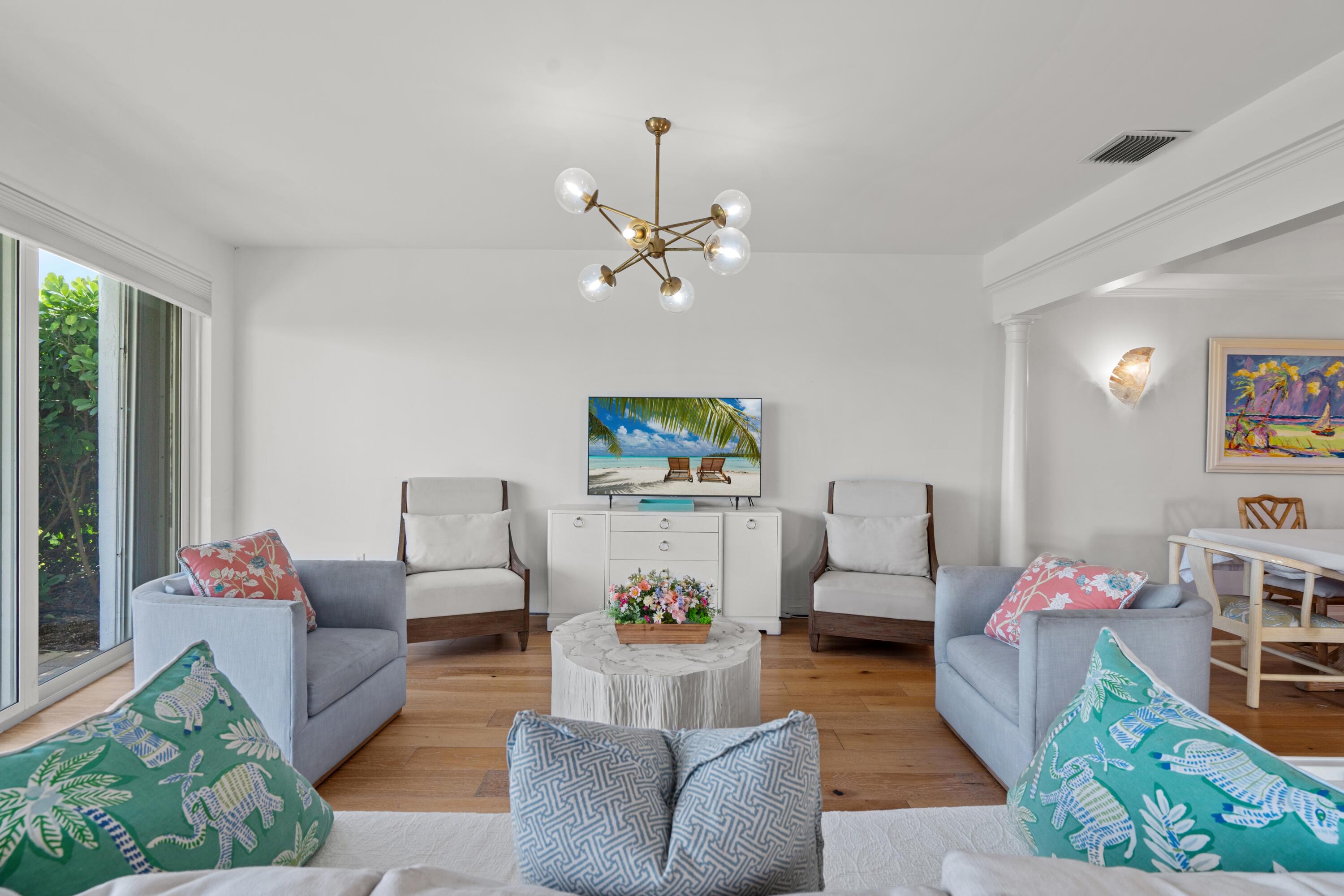 5111 North Ocean Boulevard, Unit A Ocean Ridge, FL 33435 - Photo 26 of 47 a living room with furniture and a chandelier