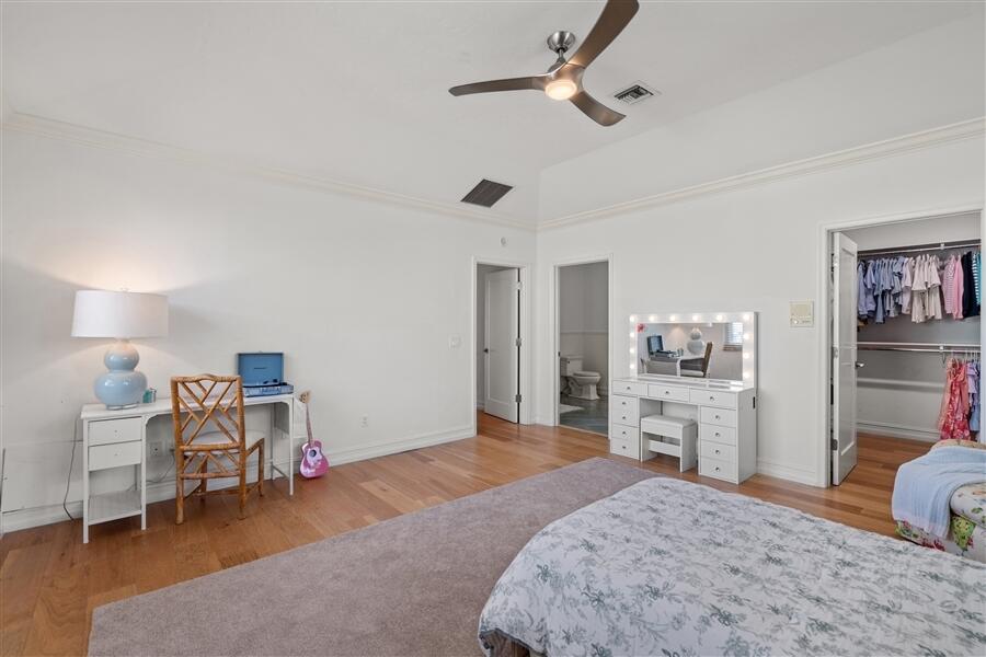 5111 North Ocean Boulevard, Unit A Ocean Ridge, FL 33435 - Photo 32 of 47 a bedroom with a bed and a chandelier