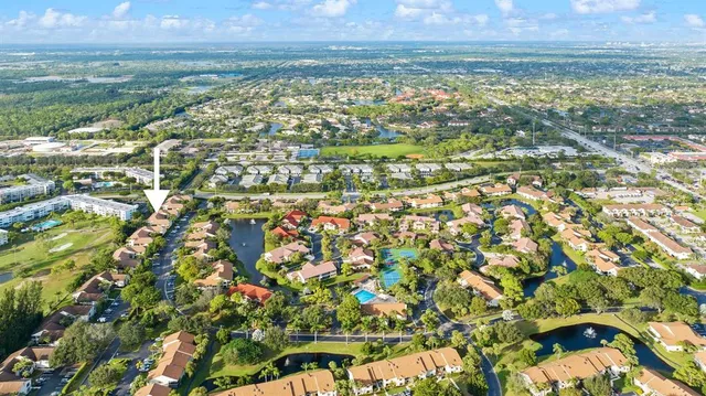 an aerial view of residential houses with outdoor space and swimming pool