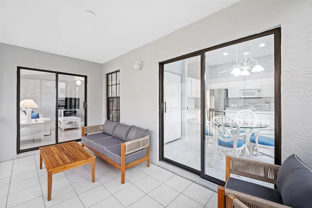 a living room with furniture and a large window with outer view