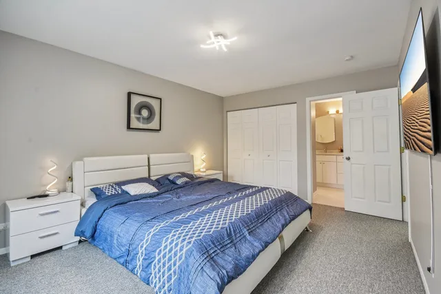 a bedroom with a bed and a painting on the wall