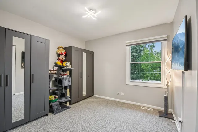 an empty room with windows and closet