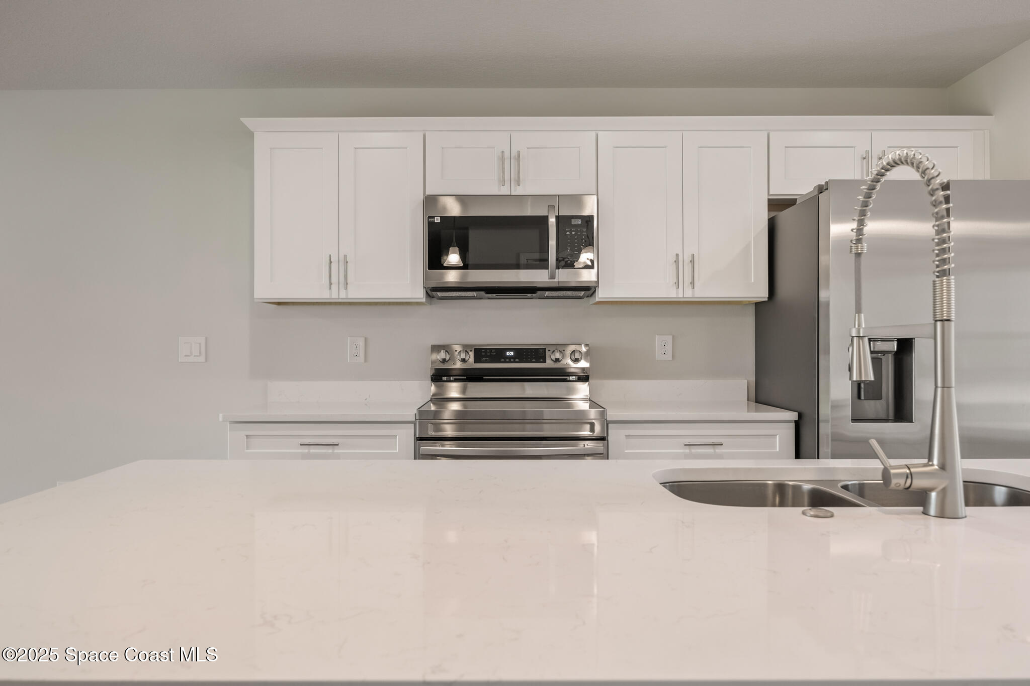 237 Hidden Woods Place Melbourne, FL 32901 - Photo 11 of 31 a kitchen with stainless steel appliances granite countertop a sink a stove and a refrigerator