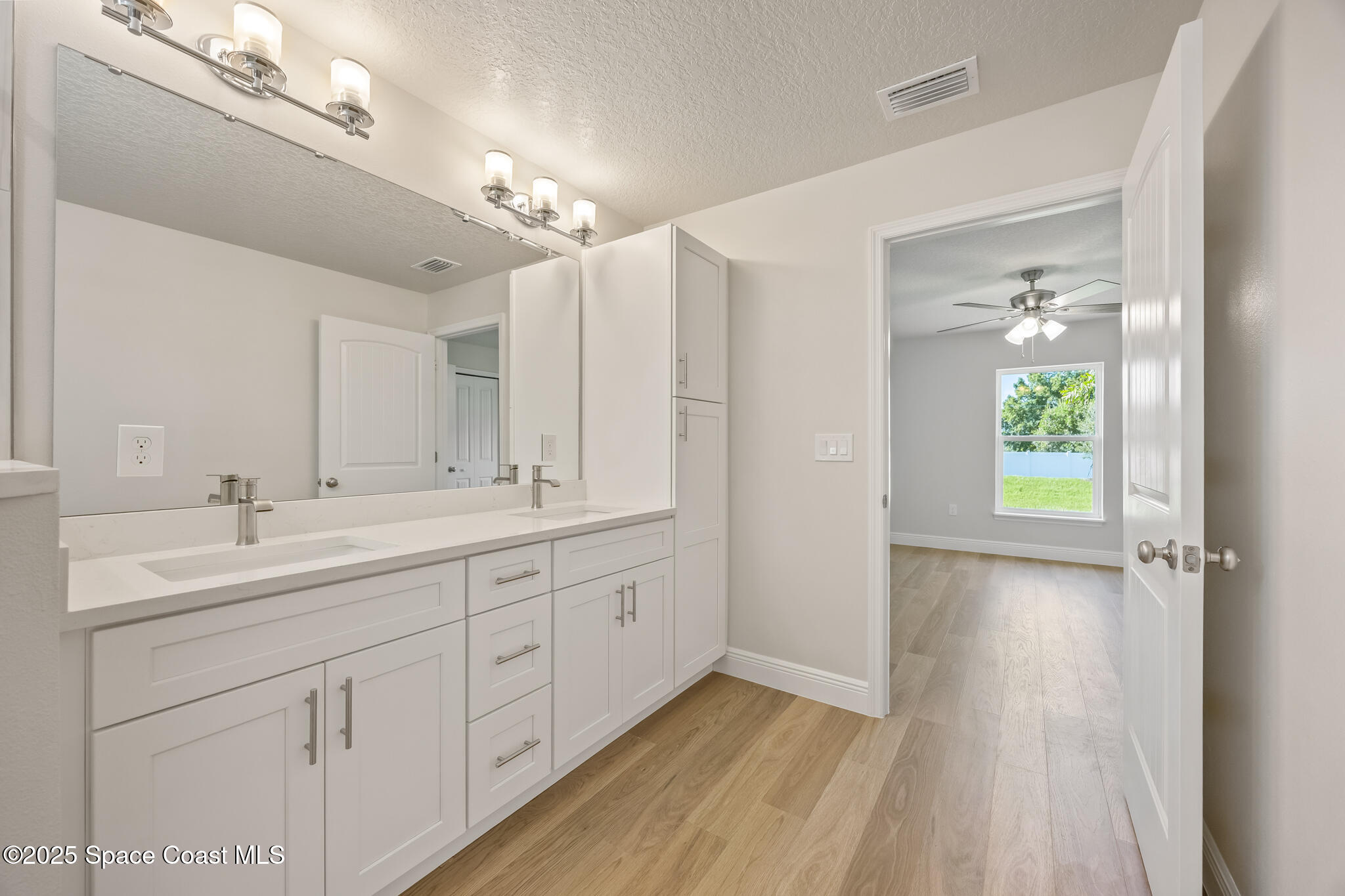 237 Hidden Woods Place Melbourne, FL 32901 - Photo 26 of 31 a bathroom with a double vanity sink and a mirror