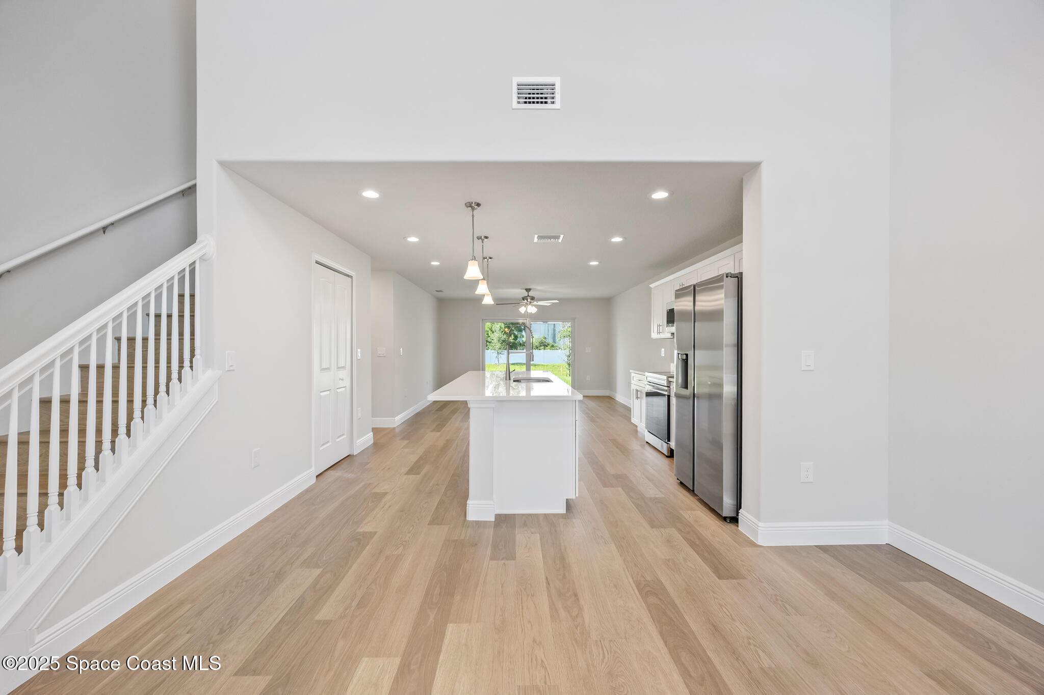 237 Hidden Woods Place Melbourne, FL 32901 - Photo 5 of 31 a view of a hallway with wooden floor and staircase