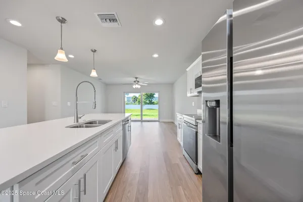 a bathroom with a sink a large mirror and a shower