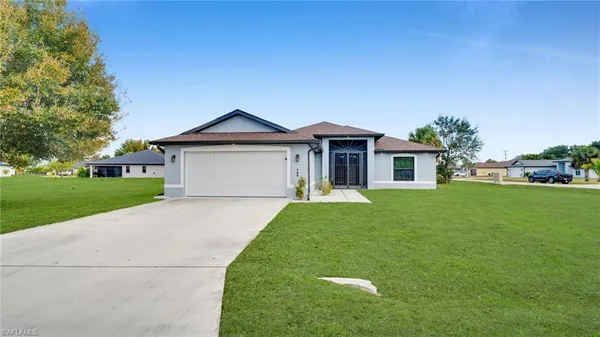 a front view of a house with a yard and garage