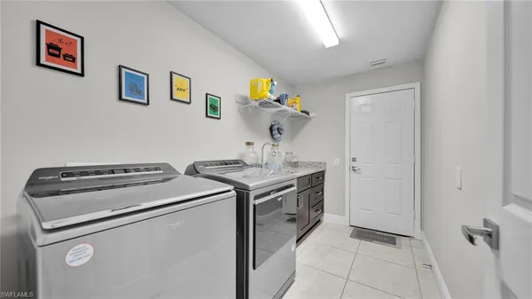 a kitchen with stainless steel appliances kitchen island granite countertop a refrigerator and a microwave