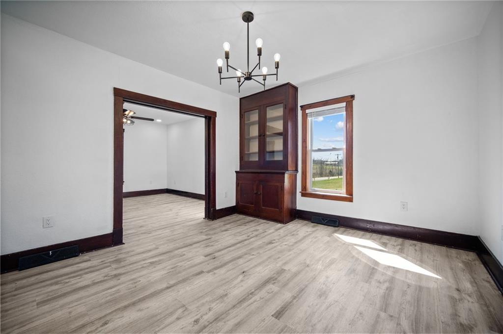 685 Herman Road Butler, PA 16002 - Photo 11 of 43 a view of an empty room with wooden floor and a window