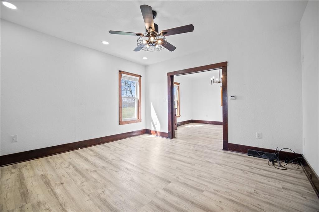 685 Herman Road Butler, PA 16002 - Photo 10 of 43 a view of an empty room with wooden floor and a ceiling fan