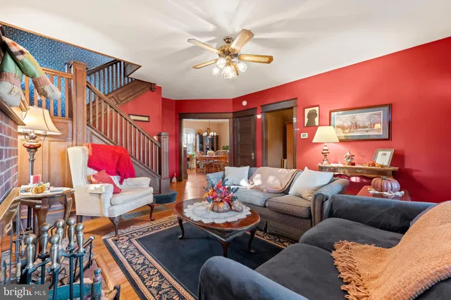 a living room with furniture and a chandelier