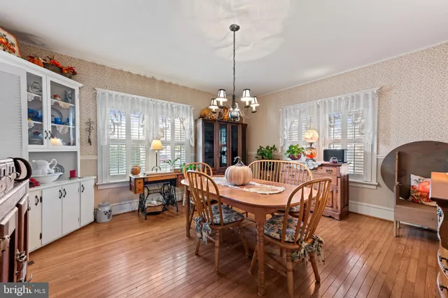 a view of a dining room with furniture wooden floor and a chandelier