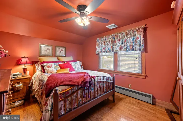 a bathroom with a tub and potted plant