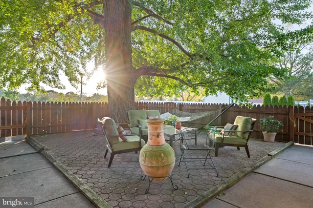 a view of a patio with table and chairs and potted plants