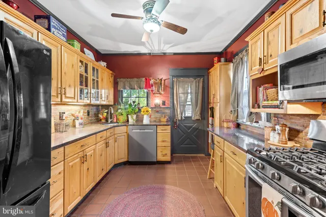 a kitchen with stainless steel appliances granite countertop a stove and a microwave