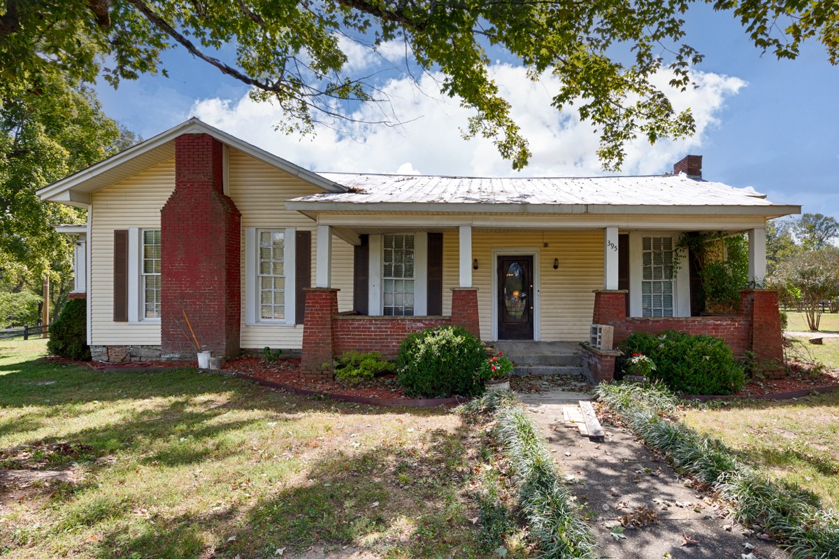 395 Case Road Prospect, TN 38477 - Photo 30 of 48 a view of a brick house with a large windows plants and large tree
