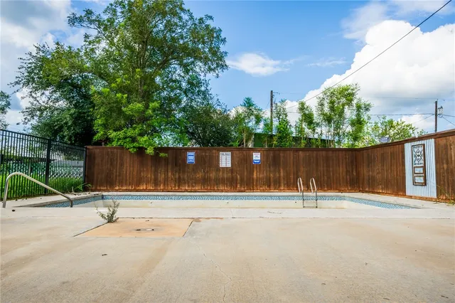 a view of swimming pool with a yard