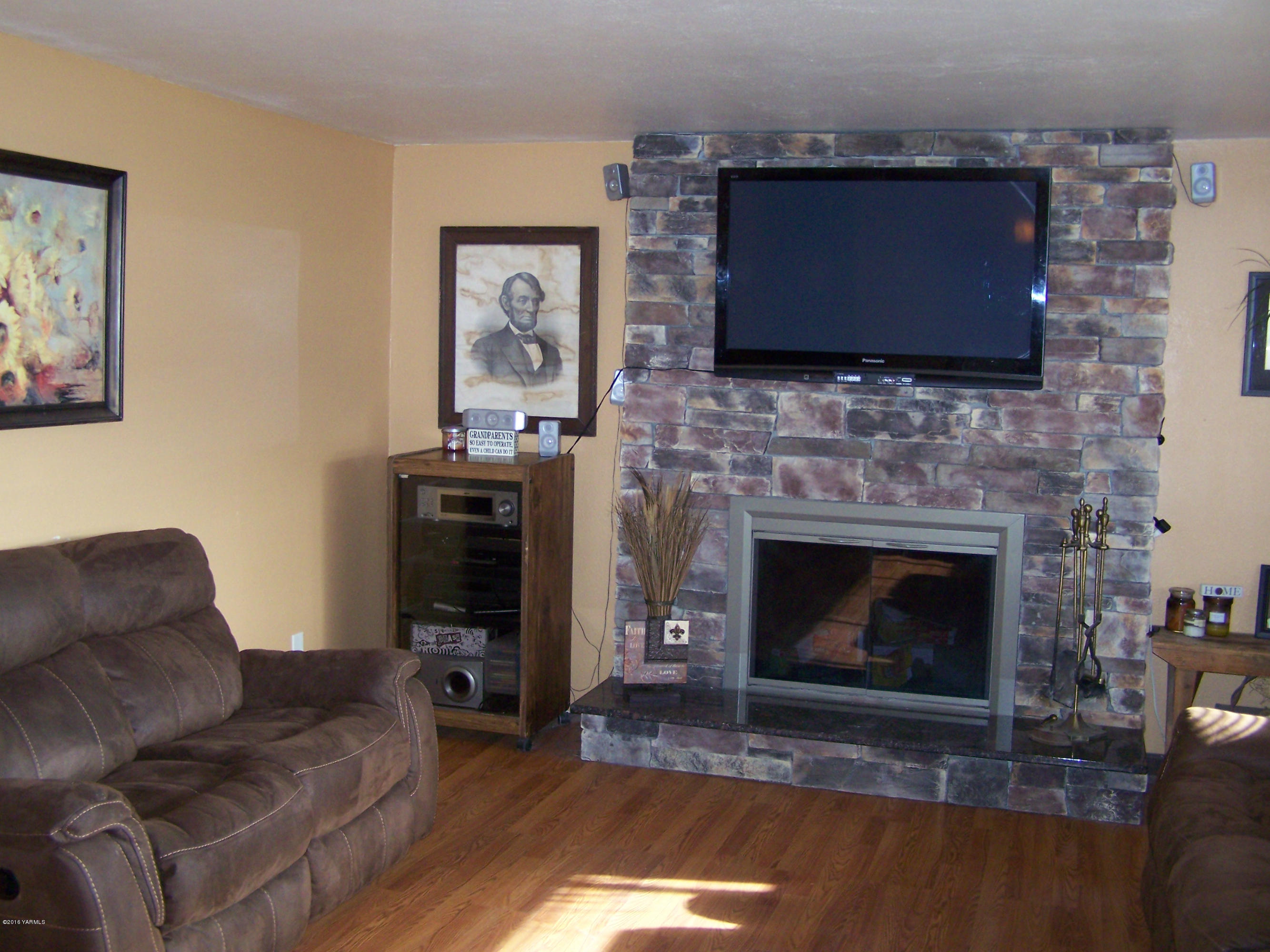 11203 Summitview Ext Road Yakima, WA 98908 - Photo 5 of 33 a living room with furniture a flat screen tv and a fireplace