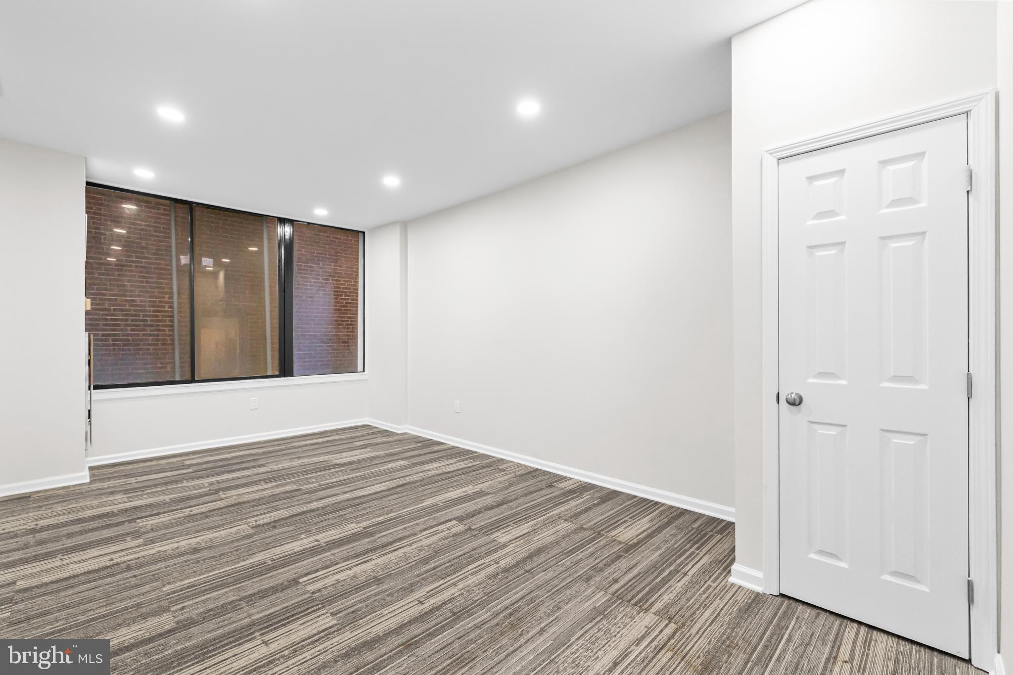 1615 Q Street Northwest, Unit T1 Washington, DC 20009 - Photo 18 of 42 a view of an empty room with wooden floor