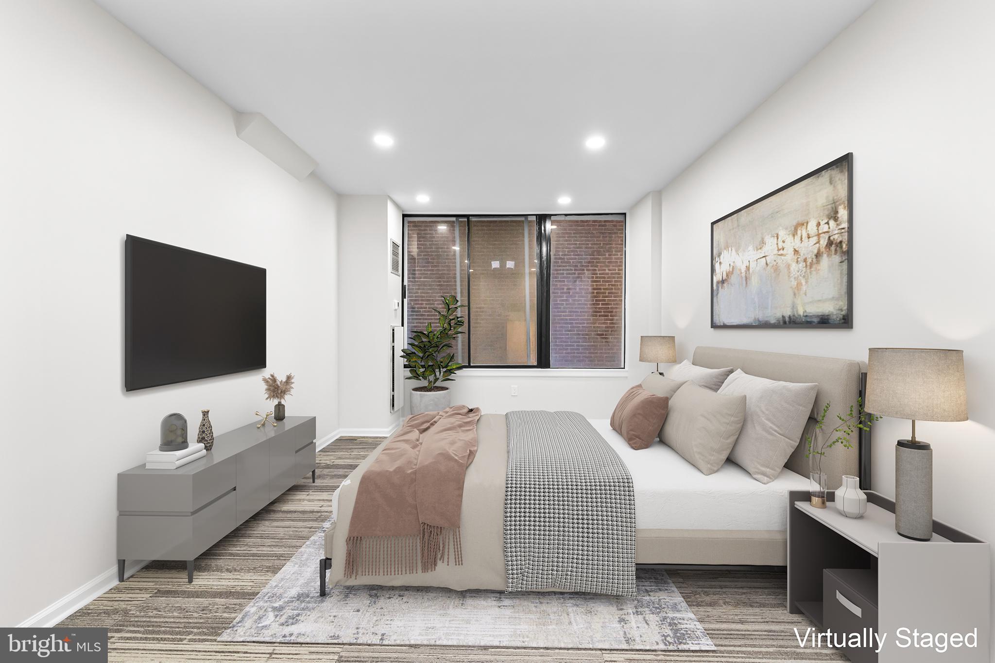 1615 Q Street Northwest, Unit T1 Washington, DC 20009 - Photo 20 of 42 a spacious bedroom with a bed and a flat screen tv