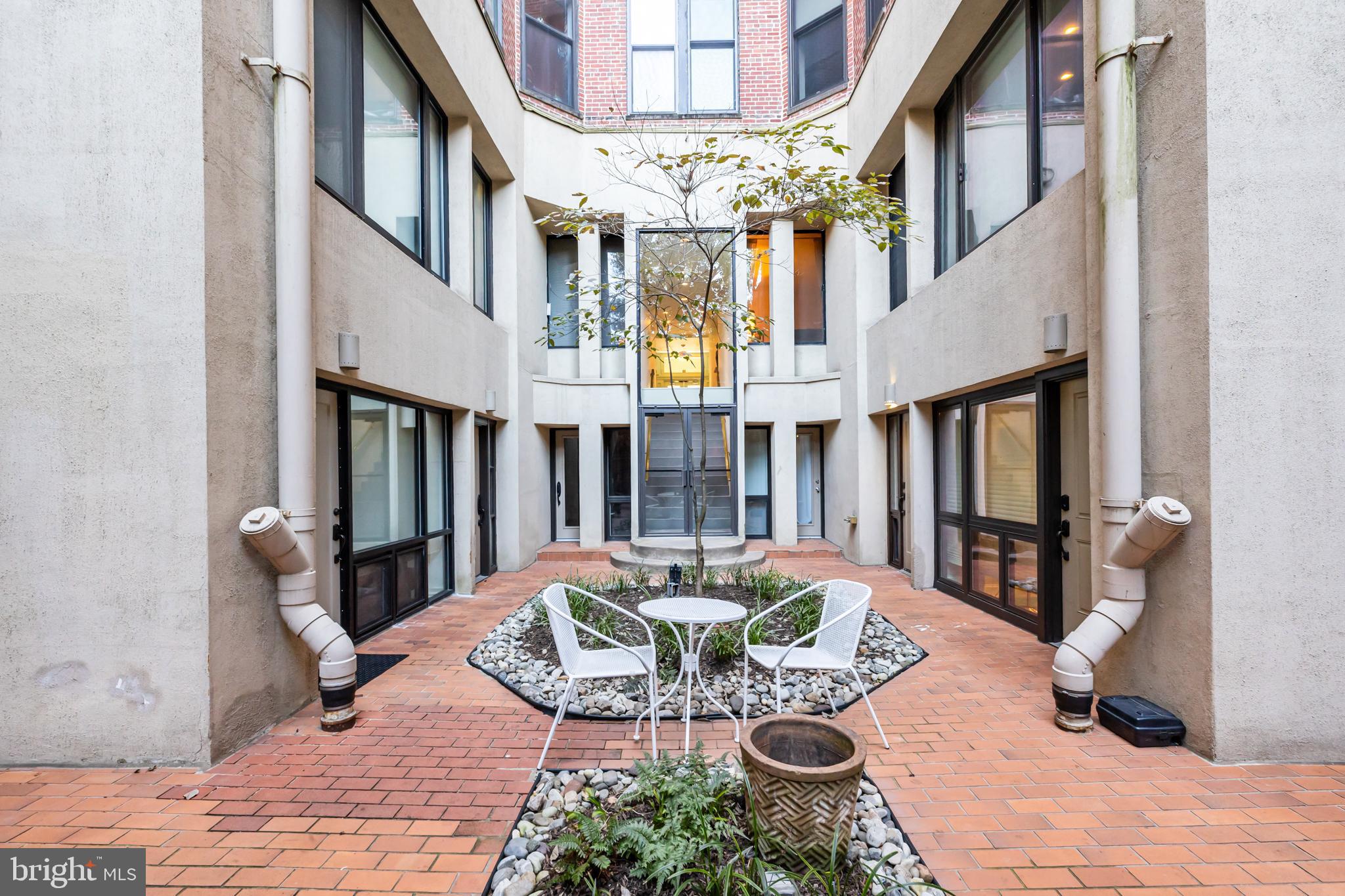 1615 Q Street Northwest, Unit T1 Washington, DC 20009 - Photo 29 of 42 a view of a livingroom with furniture a fireplace a book shelves