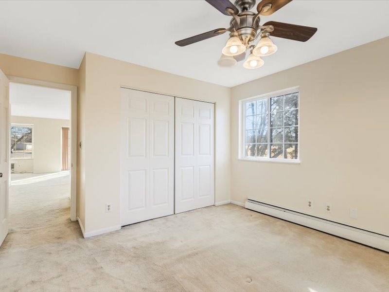 706 Kiwanis Drive, Unit 4 Freeport, IL 61032 - Photo 15 of 23 an empty room with windows and chandelier fan