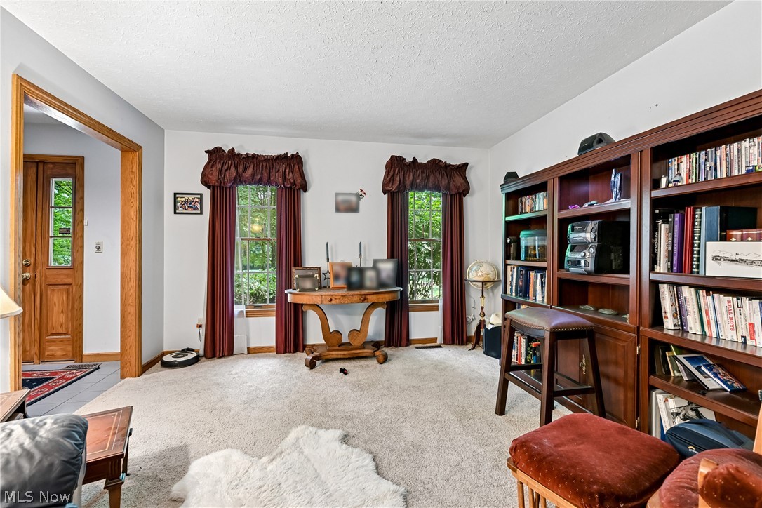 2660 South Medina Line Road Wadsworth, OH 44281 - Photo 9 of 48 Living room currently being used as a library with carpet flooring