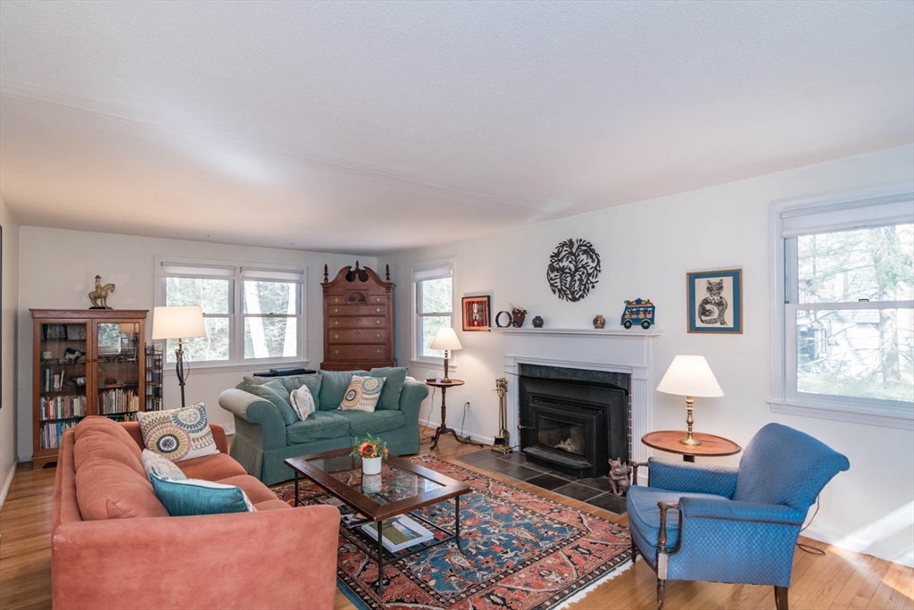 171 Aubinwood Road Amherst, MA 01002 - Photo 6 of 42 a living room with furniture a rug a fireplace and a window
