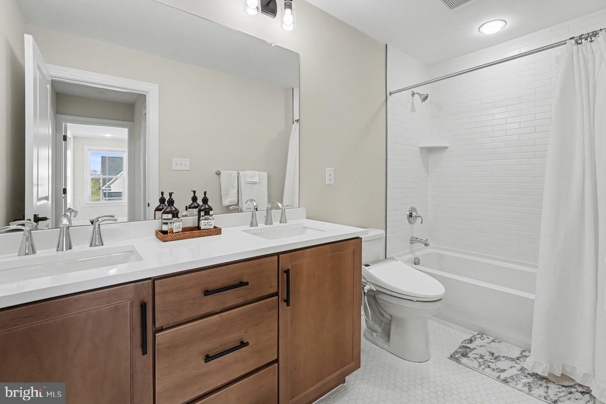 236 Indian Creek Road Telford, PA 18969 - Photo 39 of 51 a bathroom with a double vanity sink toilet mirror and bathtub
