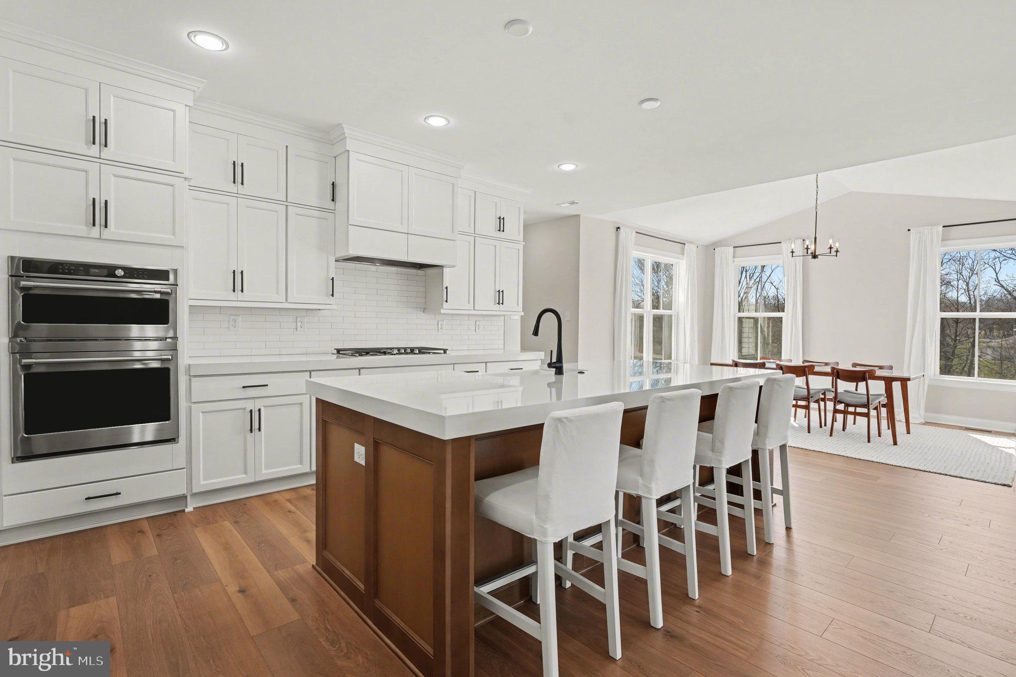 236 Indian Creek Road Telford, PA 18969 - Photo 9 of 51 a kitchen with a table chairs microwave and cabinets