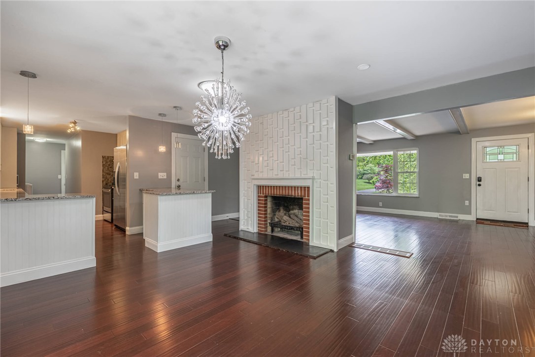 This inviting interior features a striking fireplace and lustrous hardwood floors, perfect for daily living.