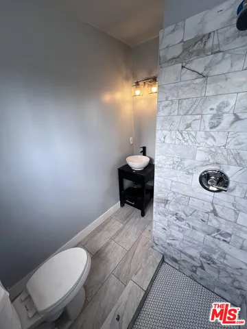 a bathroom with a toilet and a shower