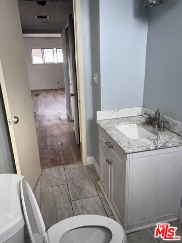 a bathroom with a granite countertop sink and a mirror