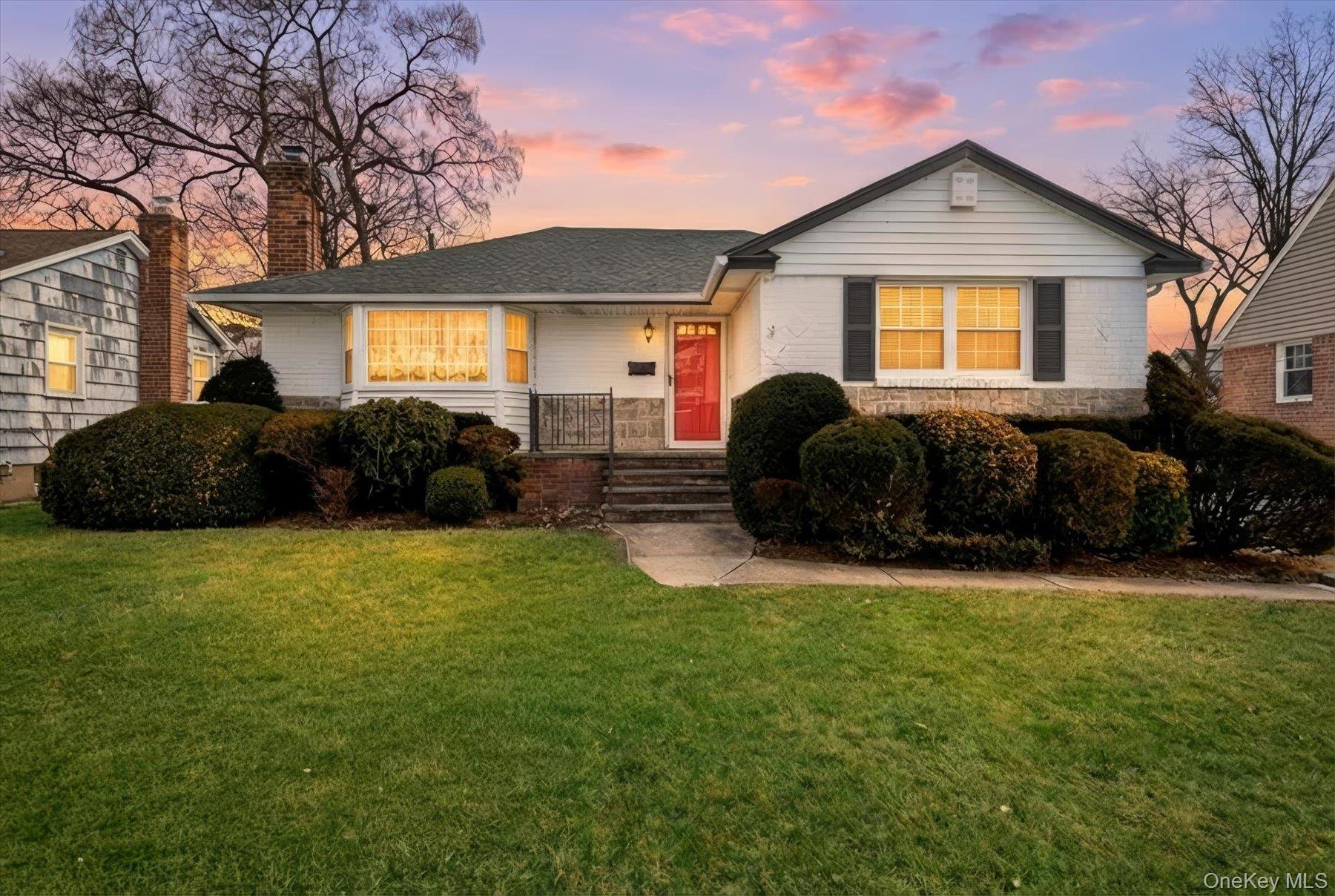 a front view of a house with a garden