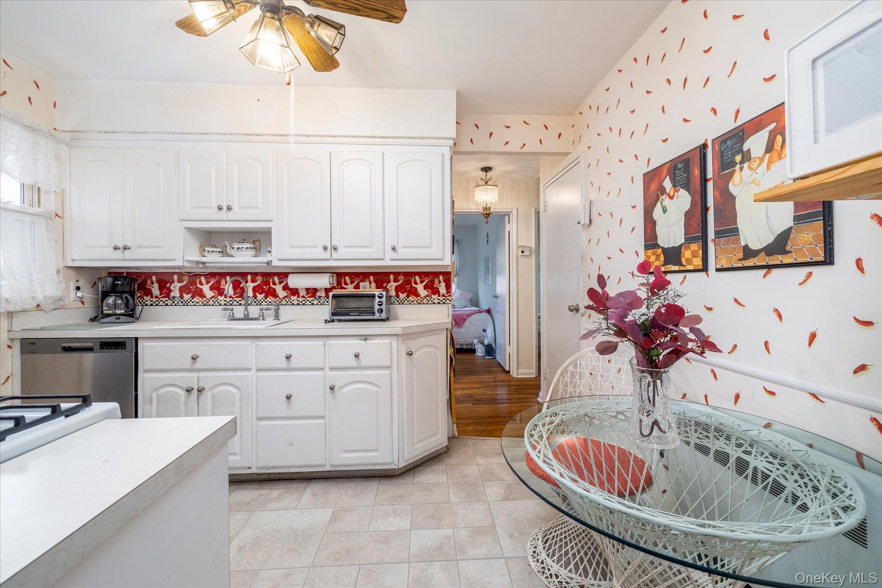 36 Wellsboro Road Valley Stream, NY 11580 - Photo 7 of 15 a kitchen with cabinets a sink and white appliances
