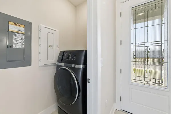 a view of a bedroom with washer and dryer