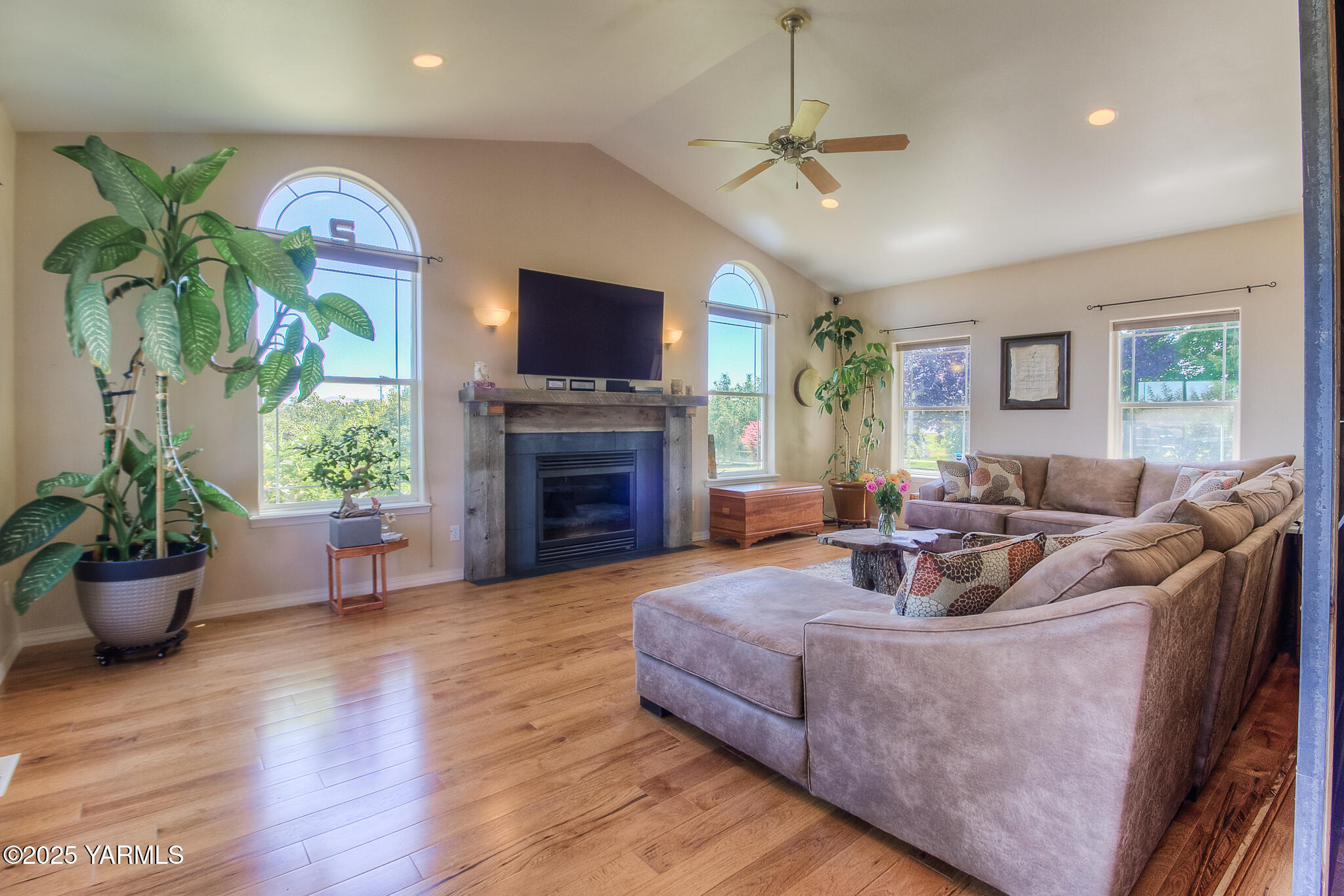 11901 Zier Road Yakima, WA 98908 - Photo 13 of 46 a living room with furniture a fireplace and a flat screen tv
