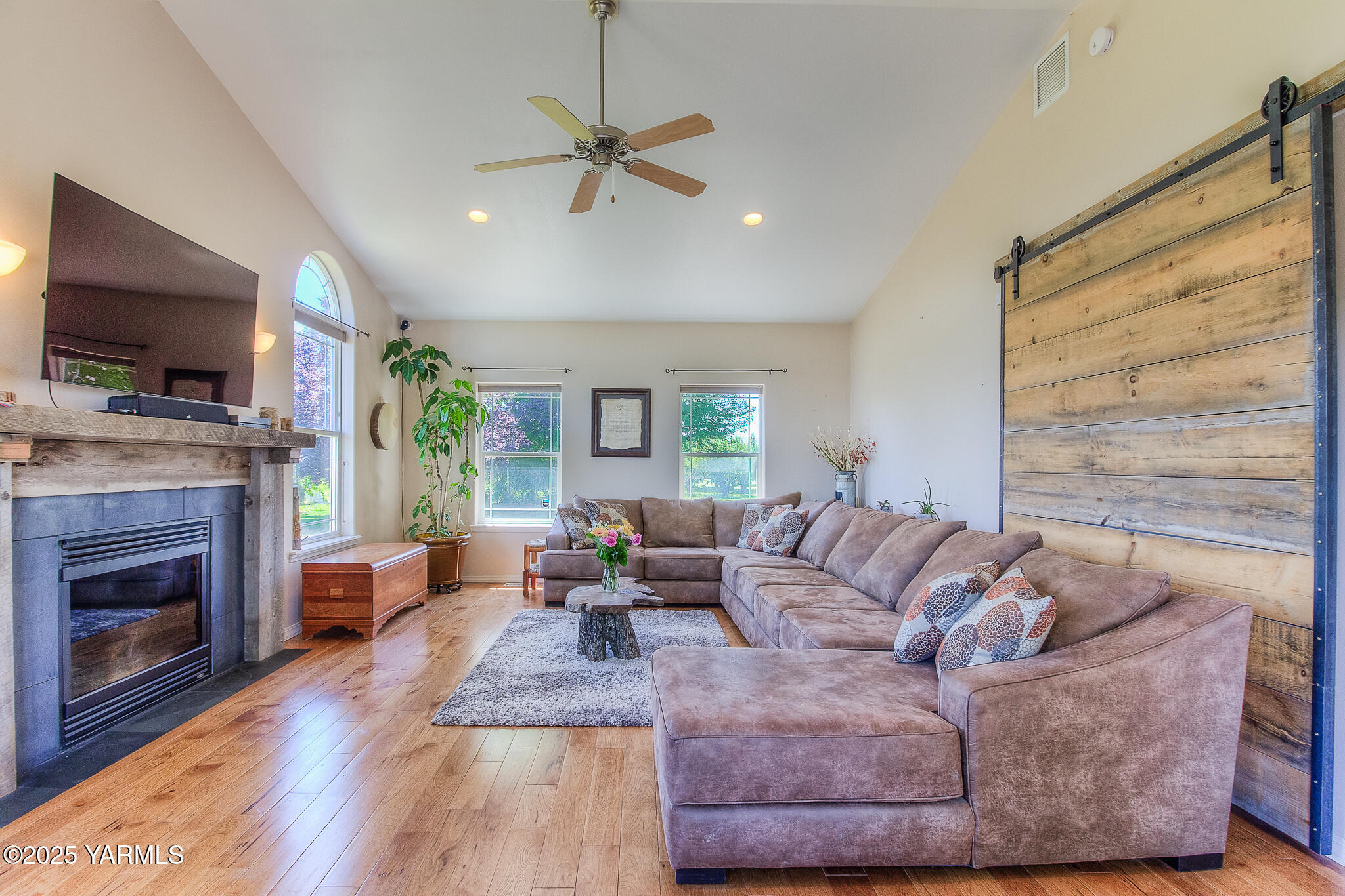11901 Zier Road Yakima, WA 98908 - Photo 14 of 46 a living room with furniture a flat screen tv and a fireplace