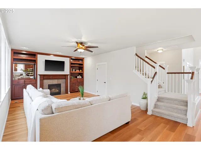 a living room with furniture a fireplace and a flat screen tv