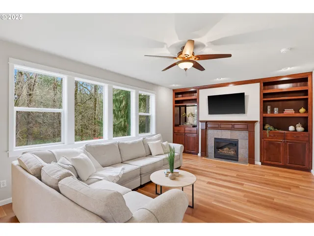 a living room with furniture a fireplace and a flat screen tv