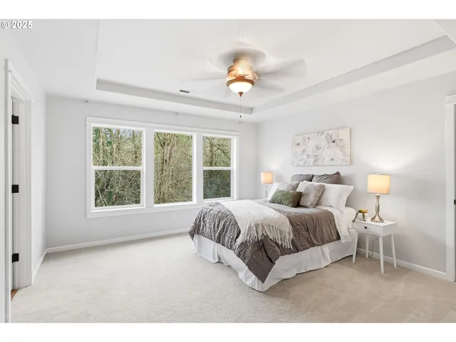 a spacious bedroom with a large bed and a large window