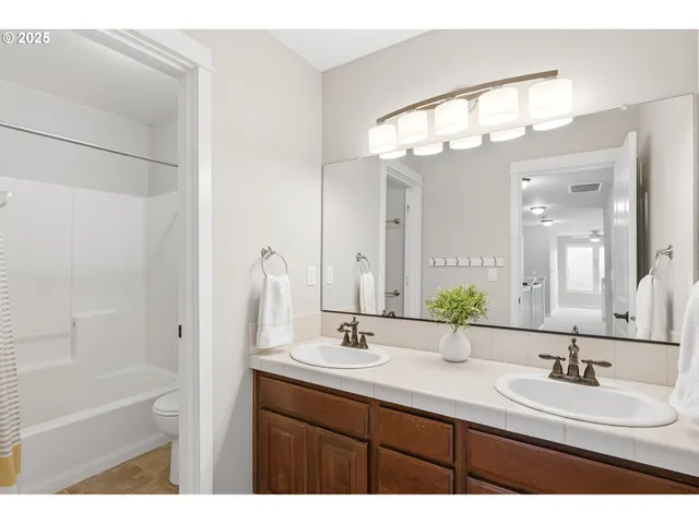 a bathroom with a sink double vanity and a mirror