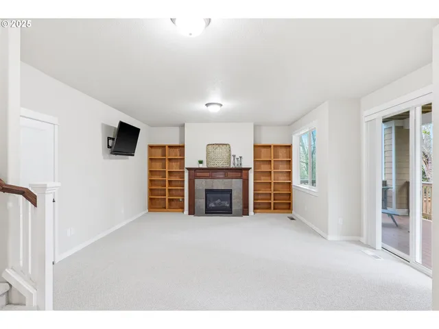 a view of a livingroom with an empty space and a fireplace