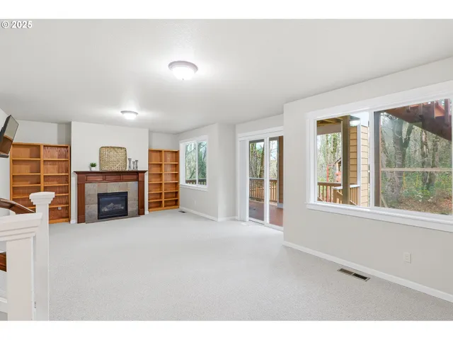 a view of a livingroom with an empty space and a fireplace