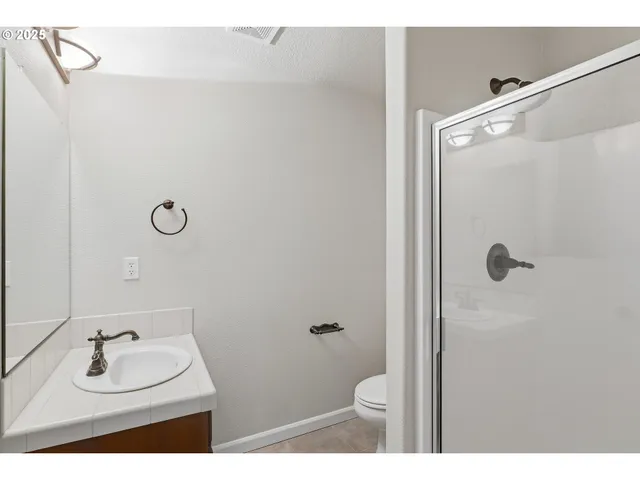 a bathroom with a sink mirror and toilet