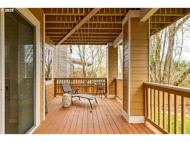 a balcony with chairs and wooden floor