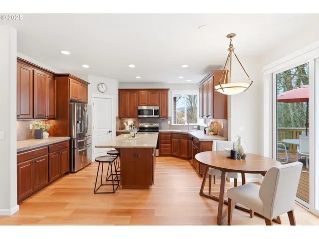 a living room with stainless steel appliances kitchen island granite countertop furniture and a kitchen view